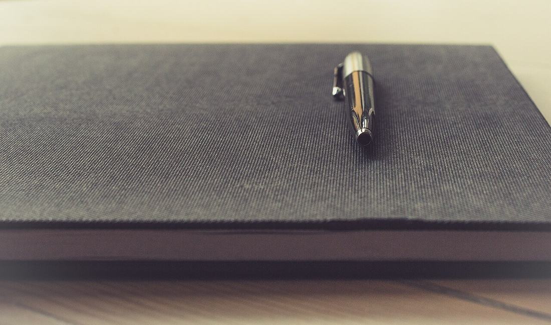 A pen resting on a notebook
