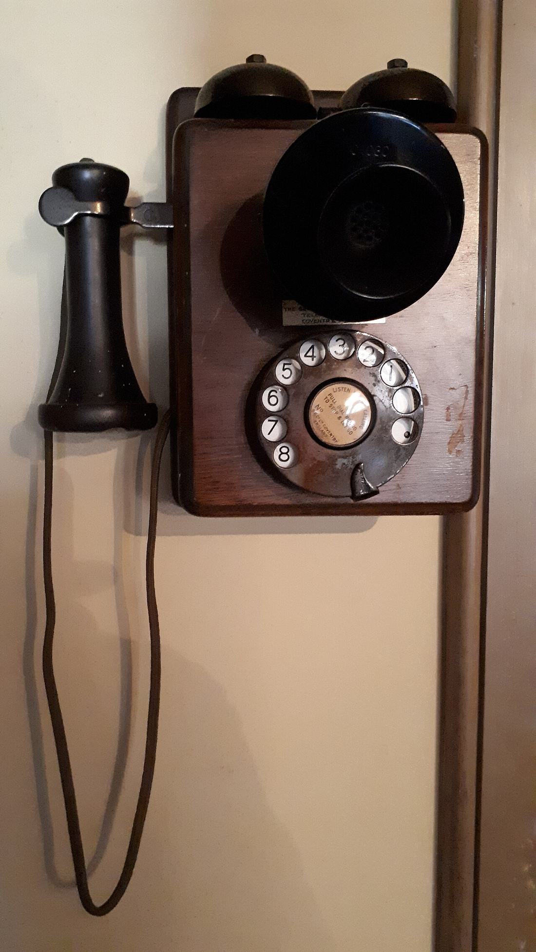 An old wall-mounted telephone